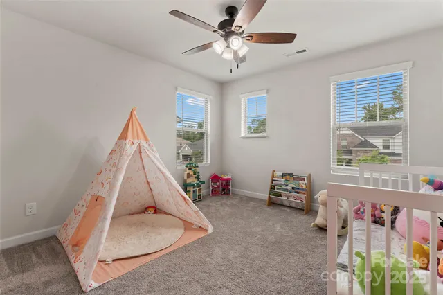 a view of a livingroom with furniture and a ceiling fan
