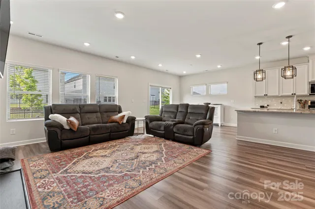 a living room with furniture window and a wooden floor