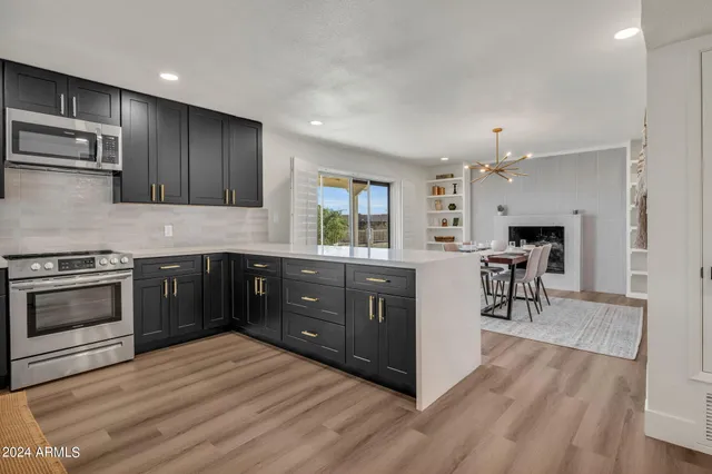 a kitchen with a stove a sink and a refrigerator