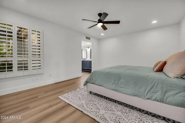 a bed sitting in a bedroom next to a window