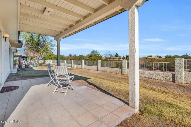 a view of a patio with a table and chairs