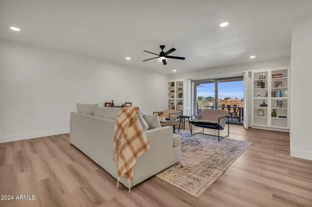 a living room with furniture and a wooden floor