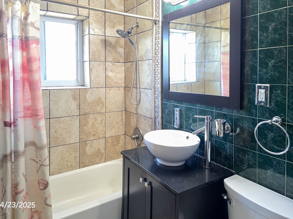 20 Westgate Road, Unit 6 Boston, MA 02467 - Photo 14 of 25 a bathroom with a sink a toilet and shower