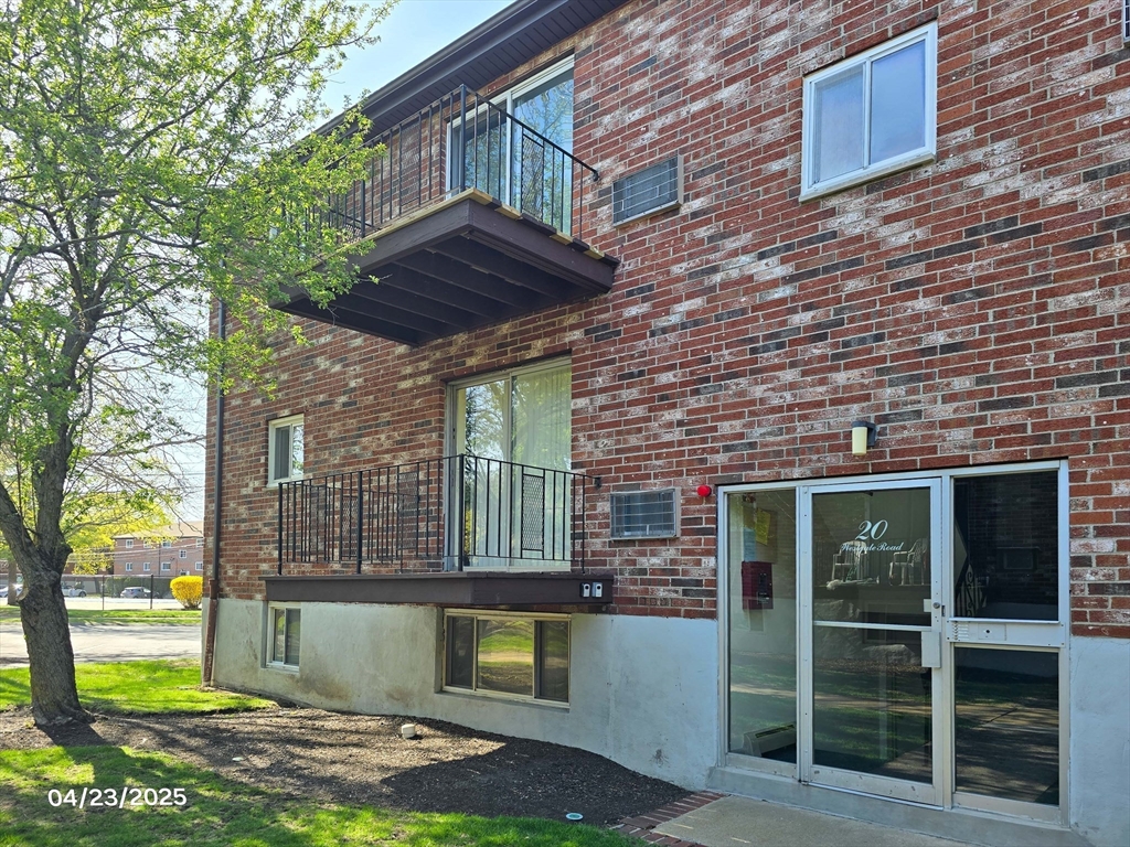20 Westgate Road, Unit 6 Boston, MA 02467 - Photo 20 of 25 a front view of a house with a garden and plants