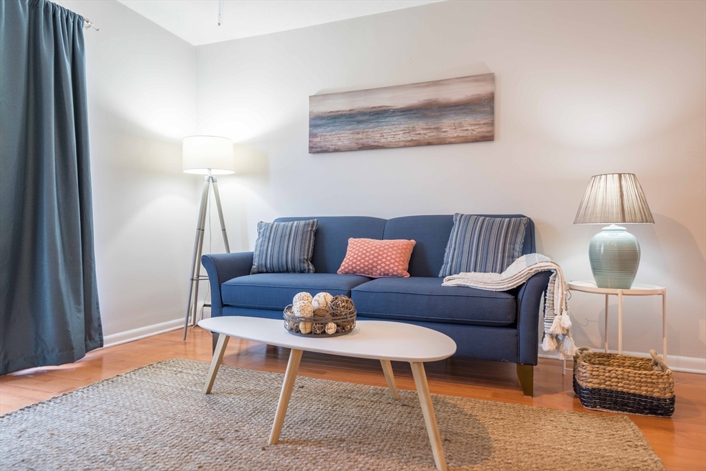 20 Westgate Road, Unit 6 Boston, MA 02467 - Photo 2 of 25 a living room with furniture and a lamp