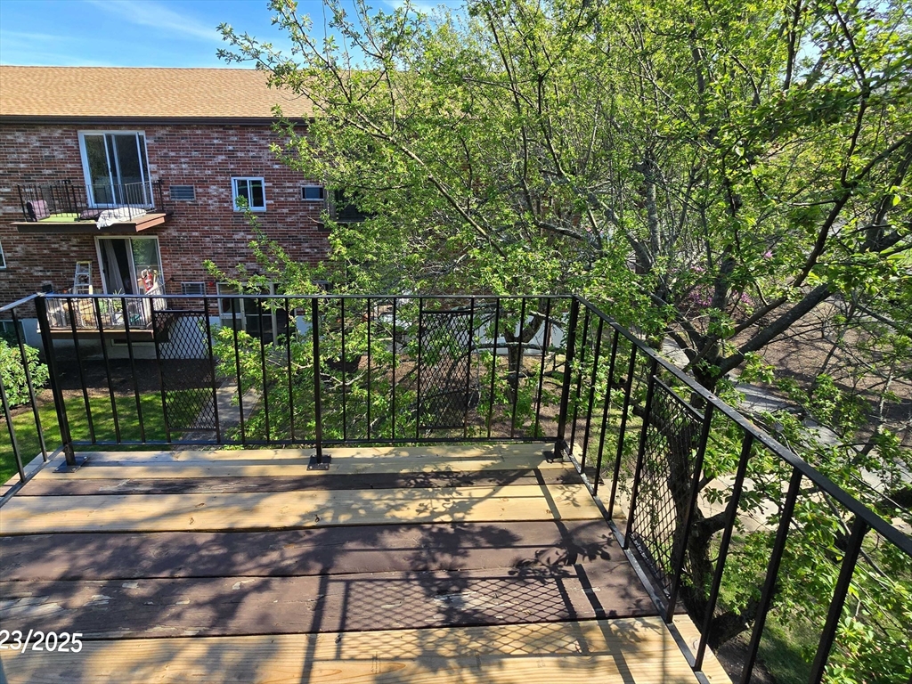 20 Westgate Road, Unit 6 Boston, MA 02467 - Photo 21 of 25 a view of a patio with a table and chairs under an umbrella