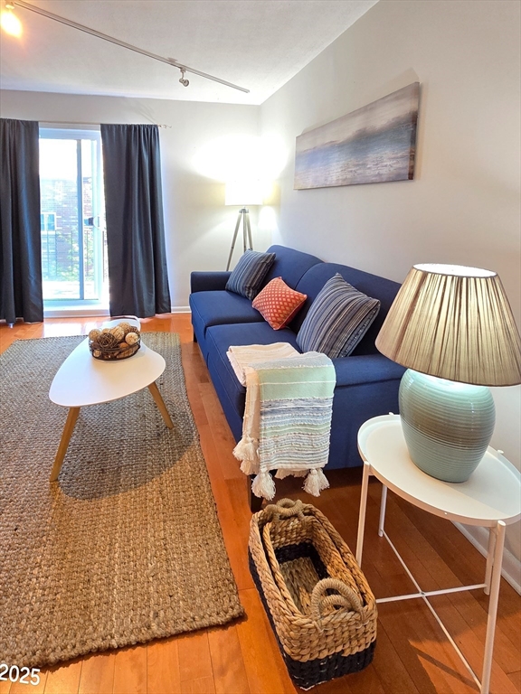 20 Westgate Road, Unit 6 Boston, MA 02467 - Photo 4 of 25 a bedroom with furniture and a window