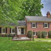 a front view of a house with a yard and green space