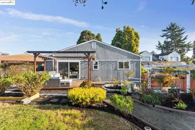 a view of a house with swimming pool and sitting area
