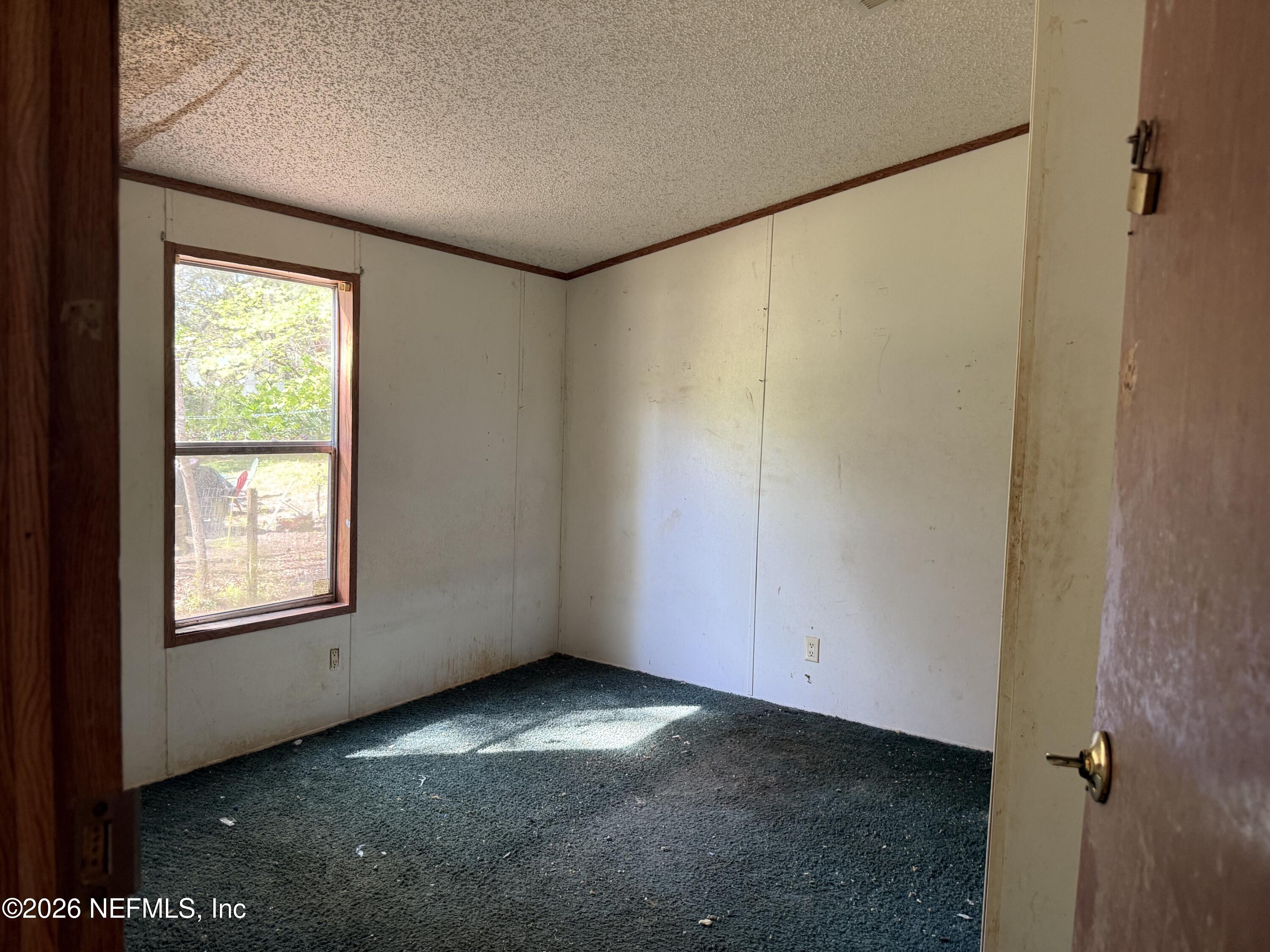 203 Quail Hollow Road Satsuma, FL 32189 - Photo 11 of 15 an empty room with windows