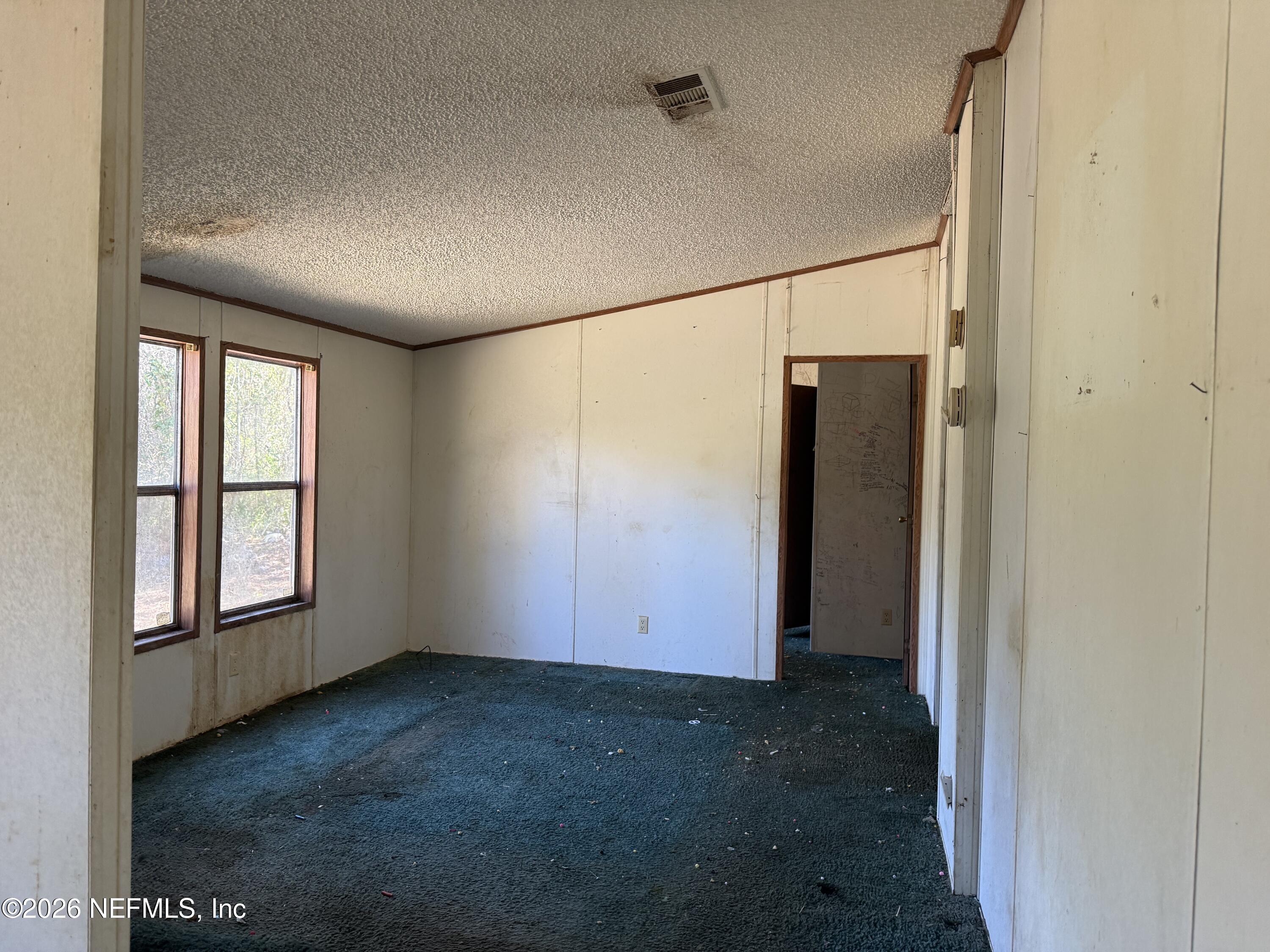 203 Quail Hollow Road Satsuma, FL 32189 - Photo 9 of 15 an empty room with windows & cabinet