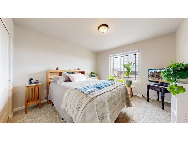 a bedroom with bed and a window