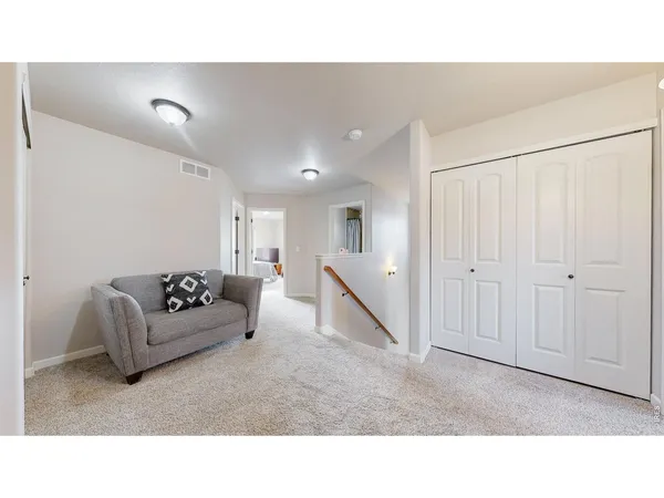 a living room with furniture and stairs