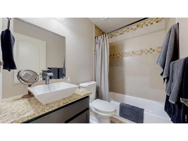 a kitchen with a refrigerator and cabinets