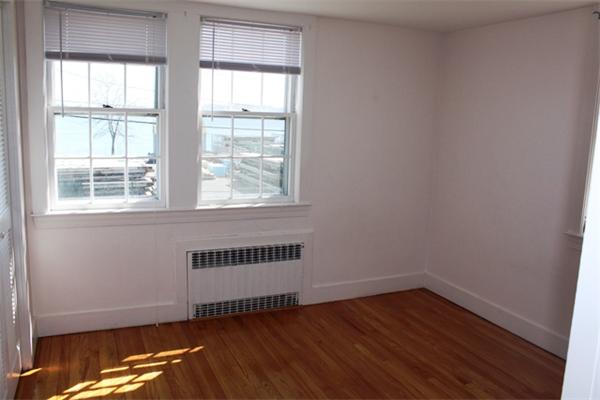 75 Jericho Road Scituate, MA 02066 - Photo 13 of 19 an empty room with wooden floor and windows