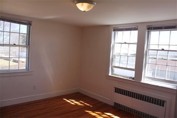 75 Jericho Road Scituate, MA 02066 - Photo 14 of 19 an empty room with wooden floor and windows