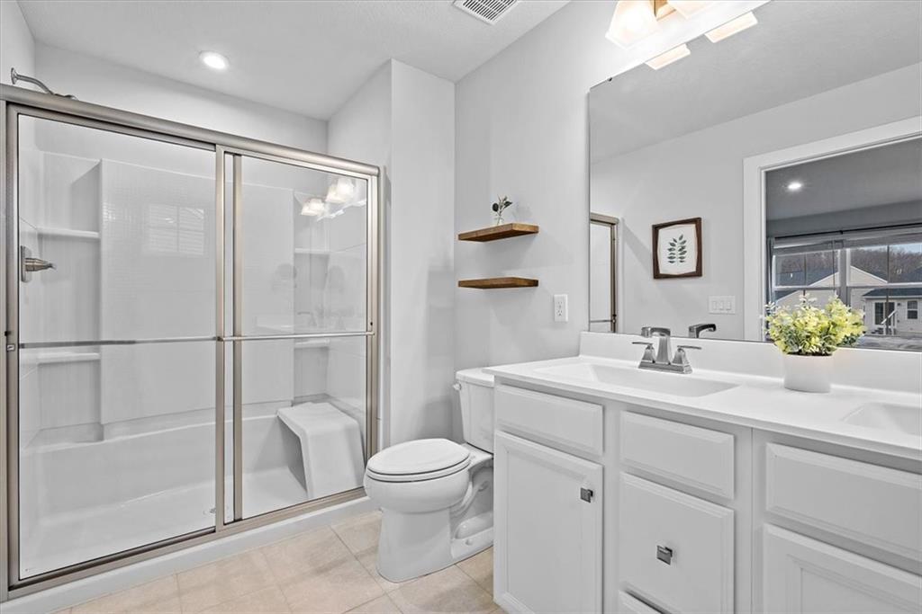 718 Celia Way Harmony, PA 16037 - Photo 12 of 23 a bathroom with a toilet sink vanity granite and shower