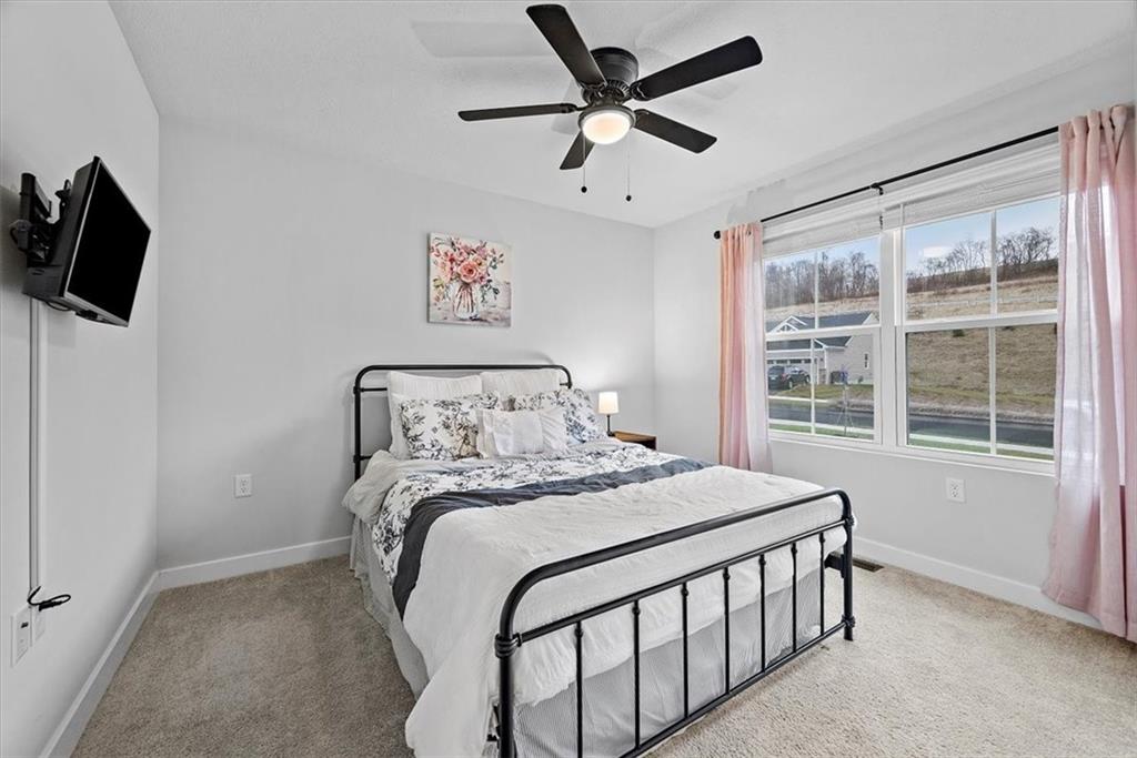 718 Celia Way Harmony, PA 16037 - Photo 13 of 23 a bedroom with a bed a flat screen tv and a window