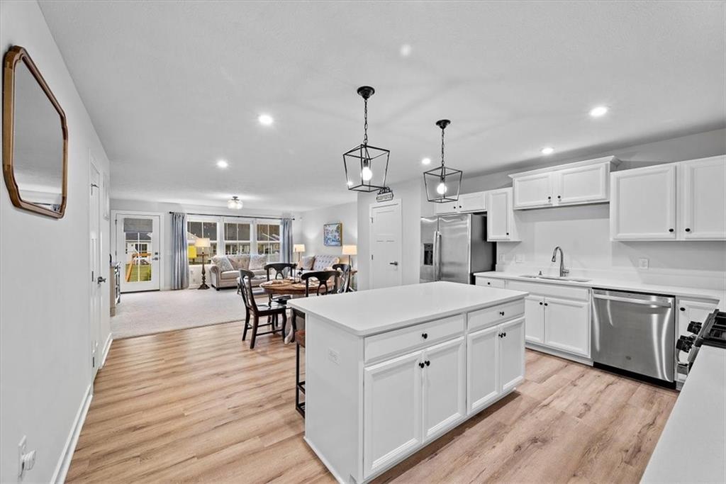 718 Celia Way Harmony, PA 16037 - Photo 5 of 23 a large kitchen with kitchen island a sink table and chairs