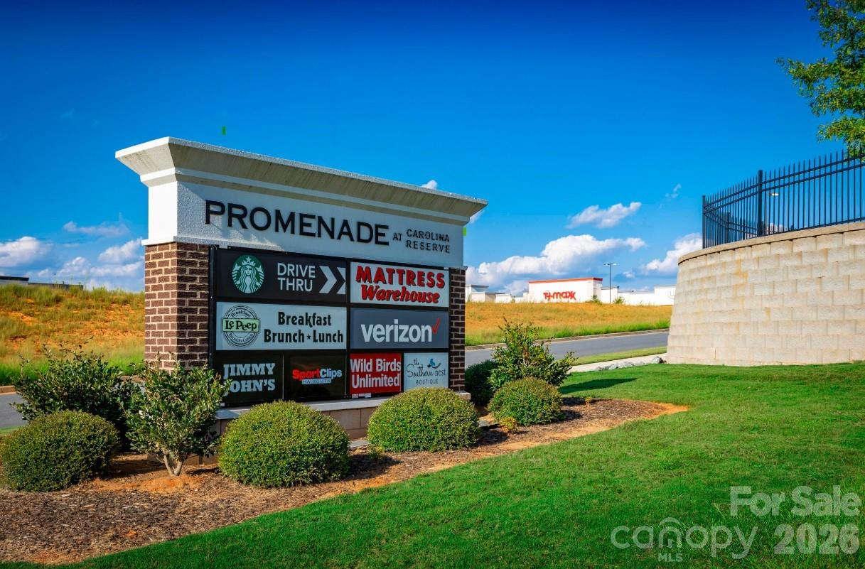 2188 Flicker Road, Unit 1036E Indian Land, SC 29707 - Photo 12 of 17 a view of a sign board with a big yard