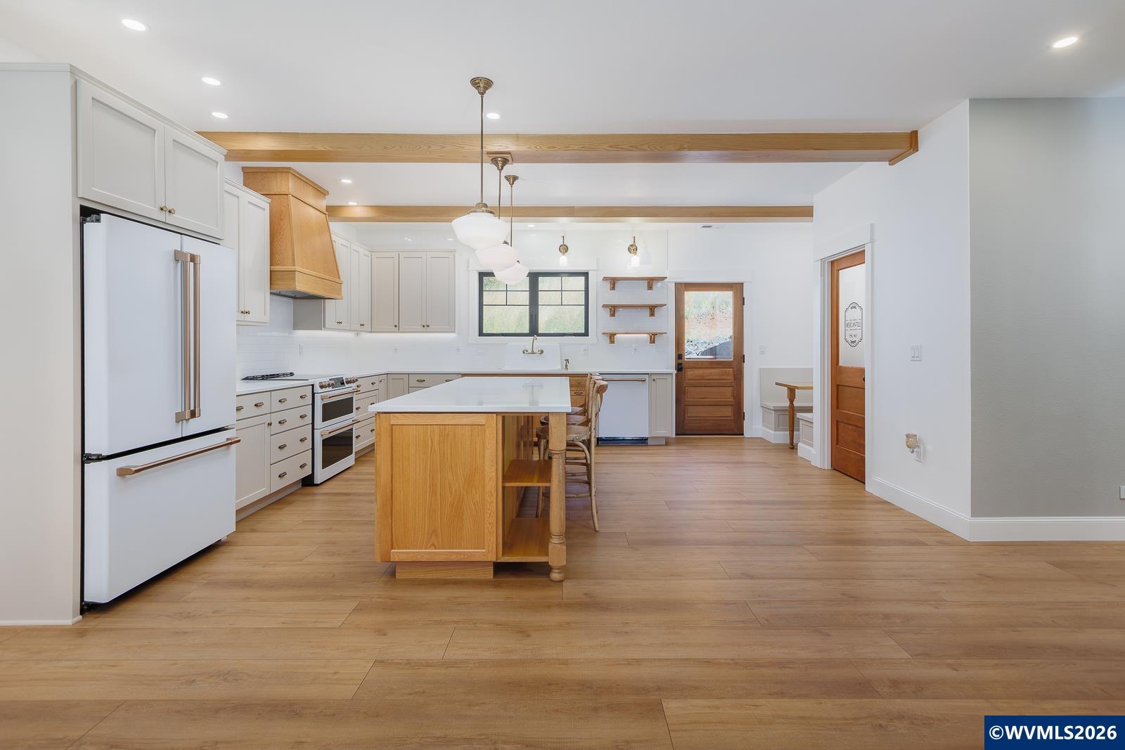 34370 Hawk Hill Road Philomath, OR 97370 - Photo 11 of 50 a kitchen with stainless steel appliances granite countertop a refrigerator a sink dishwasher and a stove with wooden floor