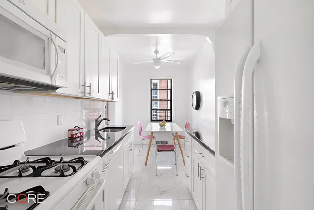 a kitchen with a sink stove and cabinets