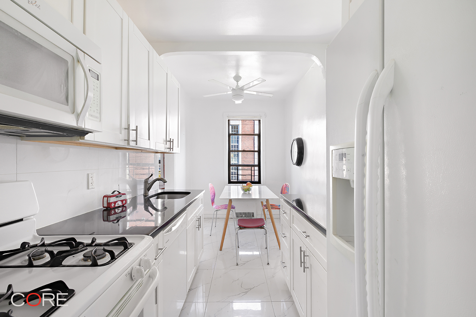 34-24 82nd Street, Unit 4N Queens, NY 11372 - Photo 4 of 10 a kitchen with a sink stove and cabinets