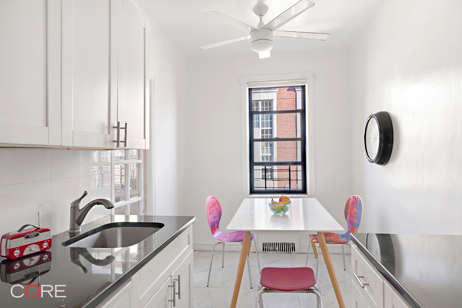 34-24 82nd Street, Unit 4N Queens, NY 11372 - Photo 5 of 10 a kitchen with a sink cabinets and entryway