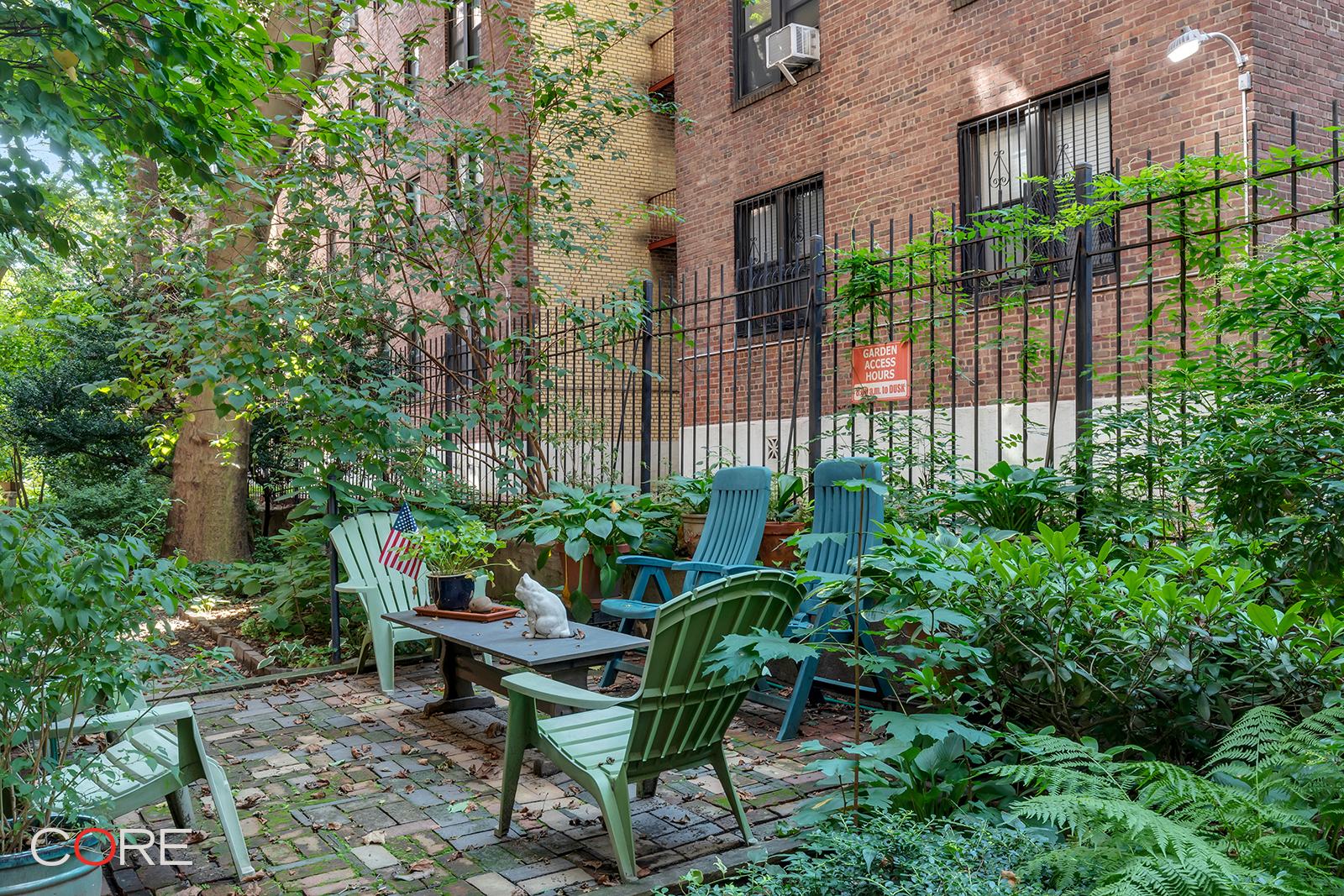 34-24 82nd Street, Unit 4N Queens, NY 11372 - Photo 8 of 10 a backyard with a table and chairs