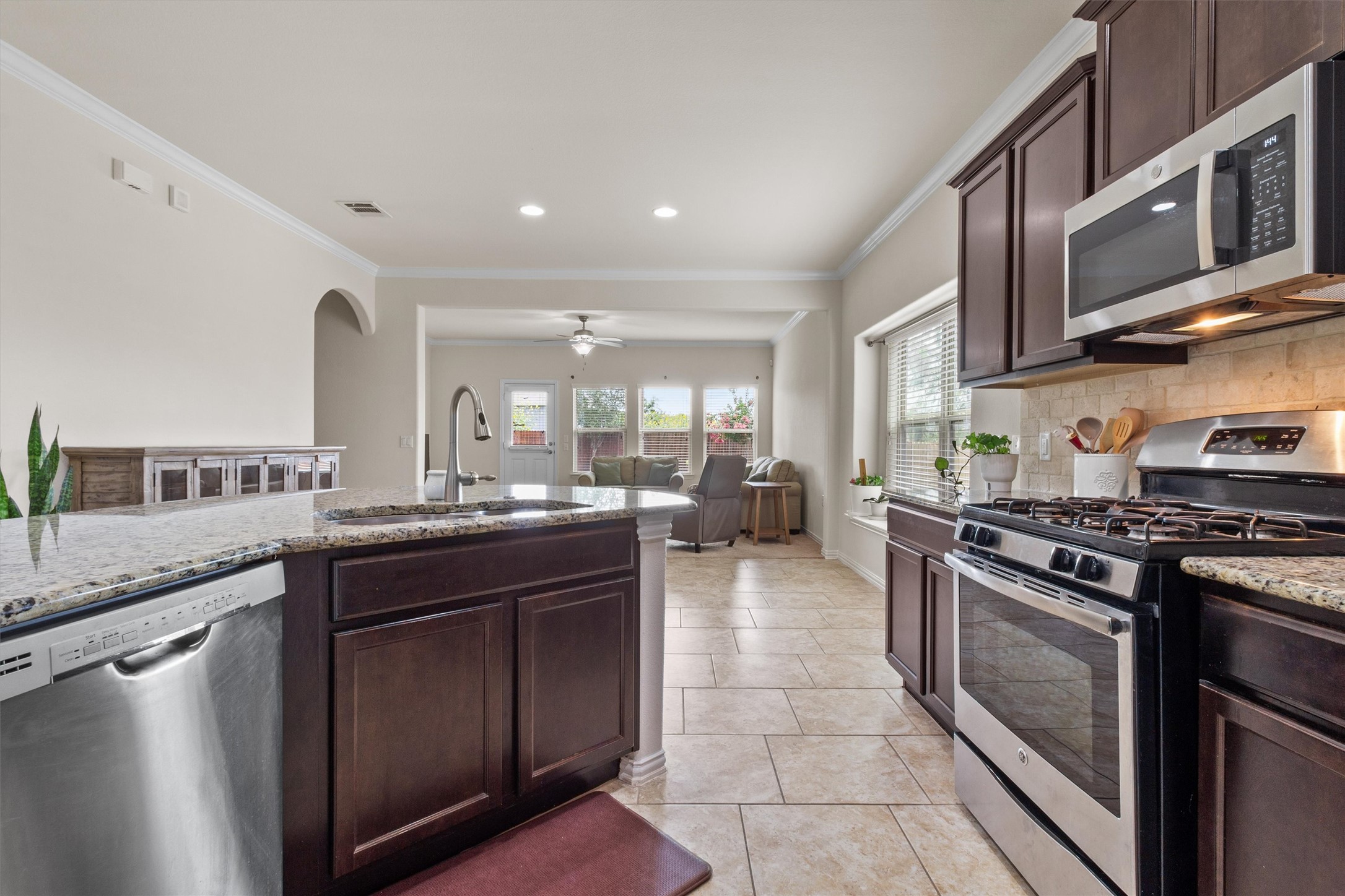 10413 Crescendo Lane Austin, TX 78747 - Photo 7 of 32 Culinary creations come alive in this kitchen, featuring ample counter space and an open view to the living area.