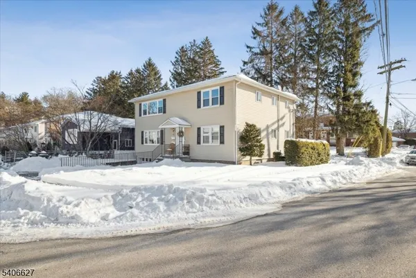 a view of a house with snow on the road