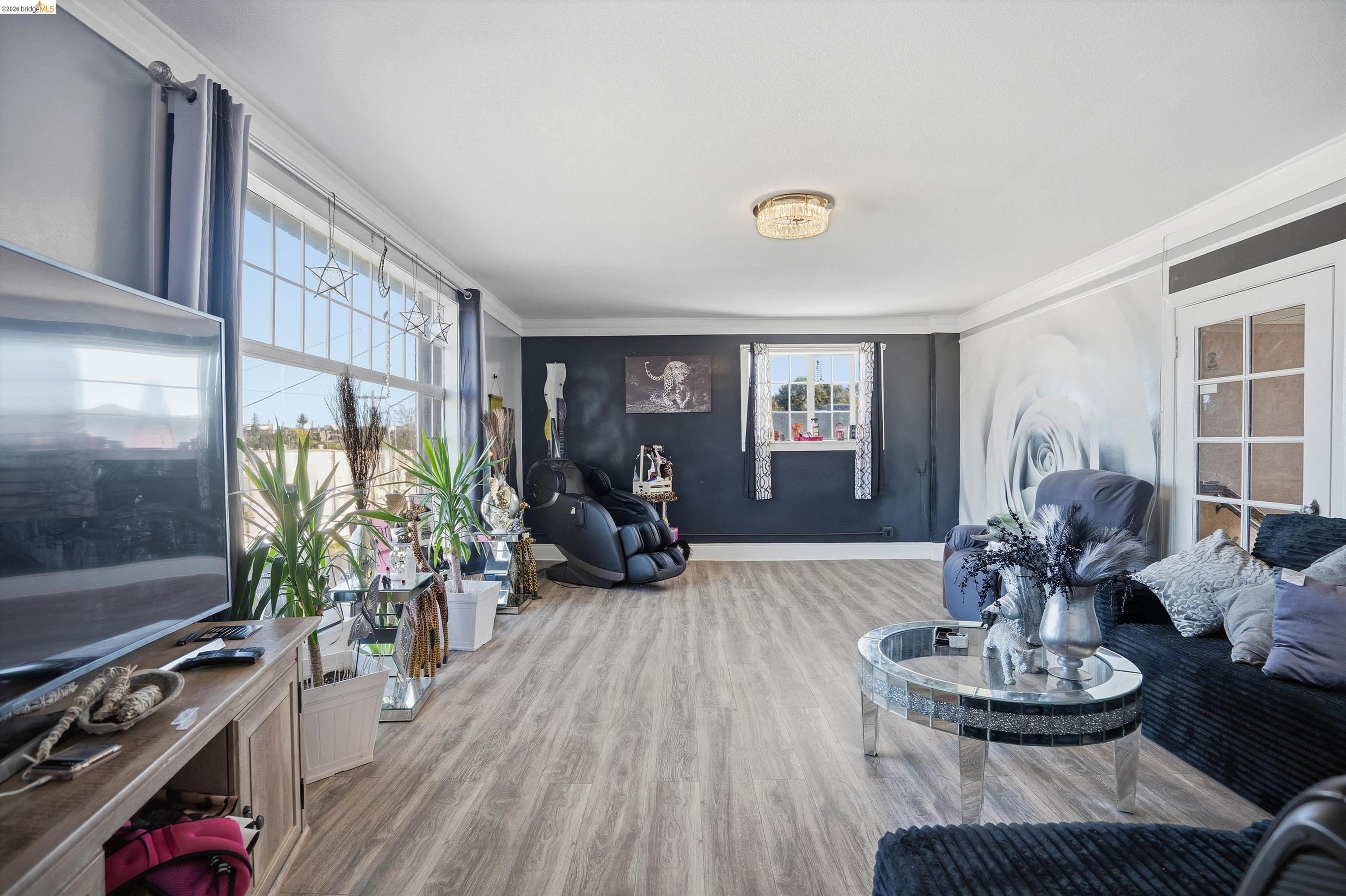 511 Third Street Rodeo, CA 94572 - Photo 2 of 25 a living room with furniture a flat screen tv and a large window
