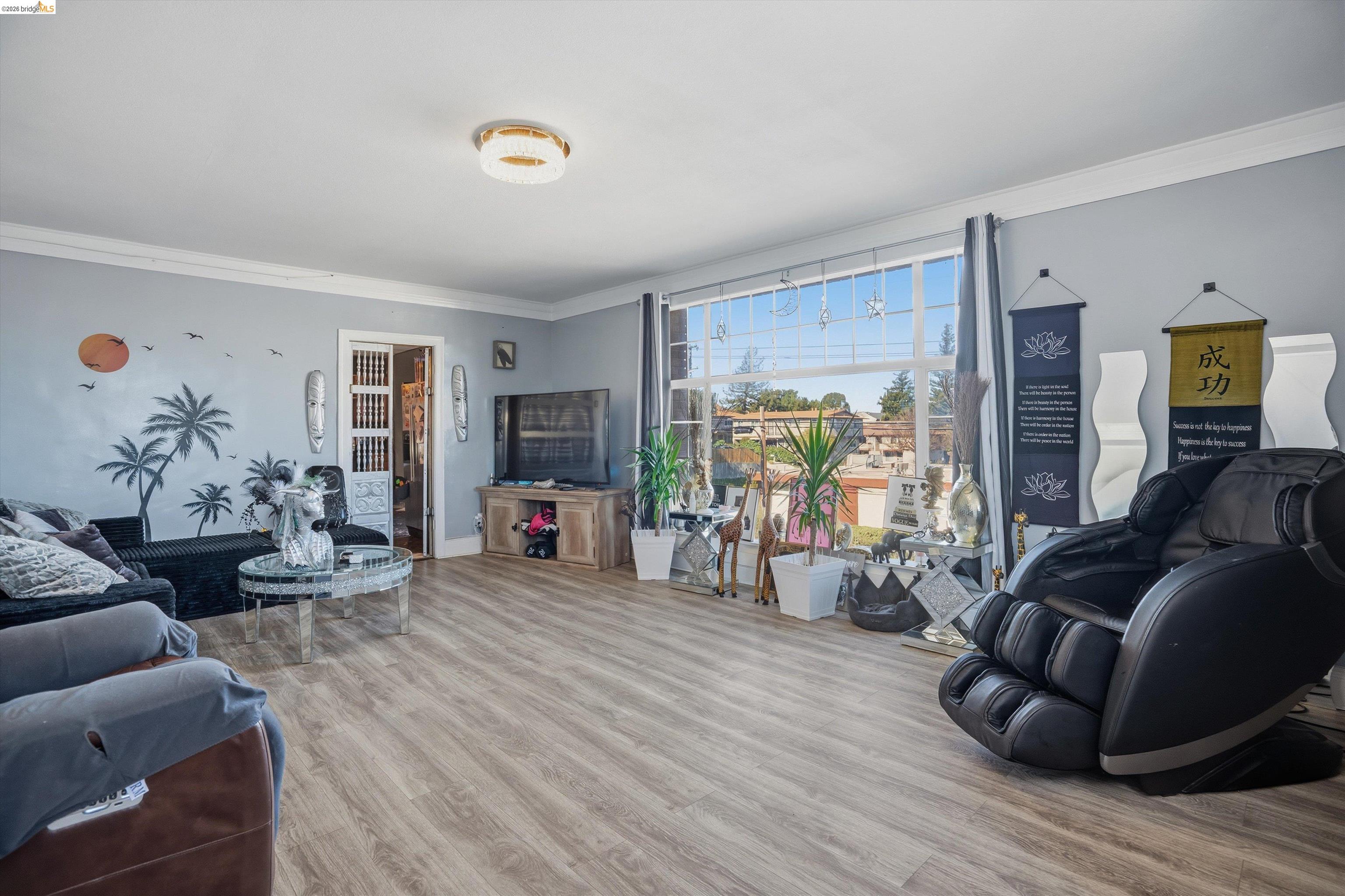 511 Third Street Rodeo, CA 94572 - Photo 3 of 25 a living room with furniture and a flat screen tv with wooden floor
