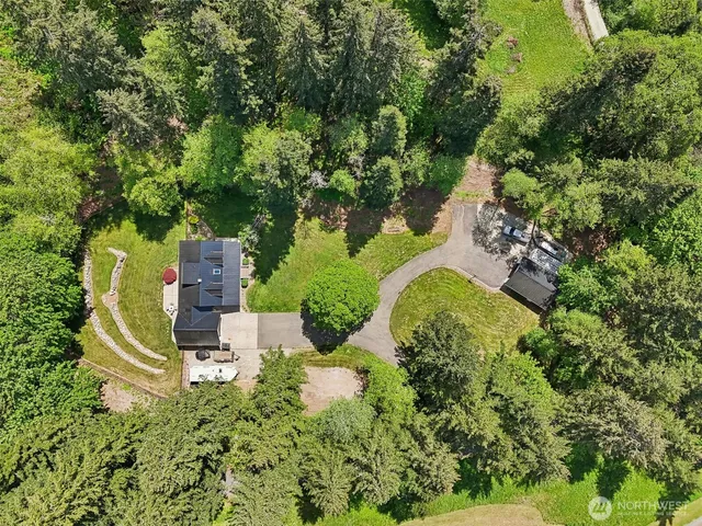 an aerial view of a house with a yard