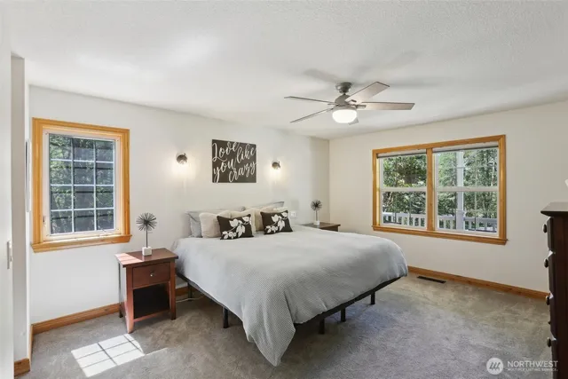 a bedroom with a bed dresser and a window