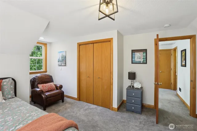 a bedroom with a bed and a couch