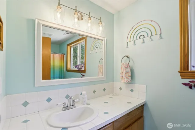 a bathroom with a sink and a mirror