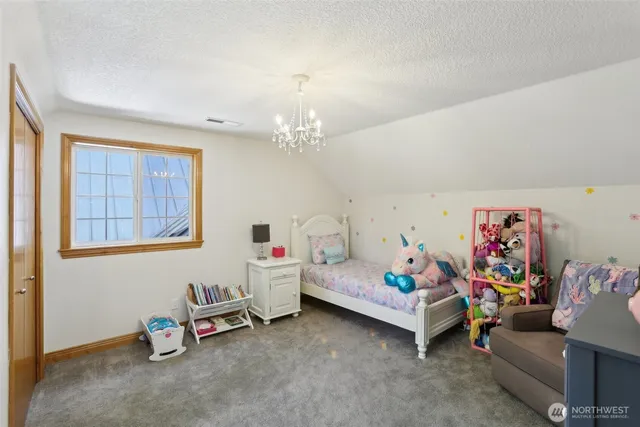 a living room with furniture and a baby crib