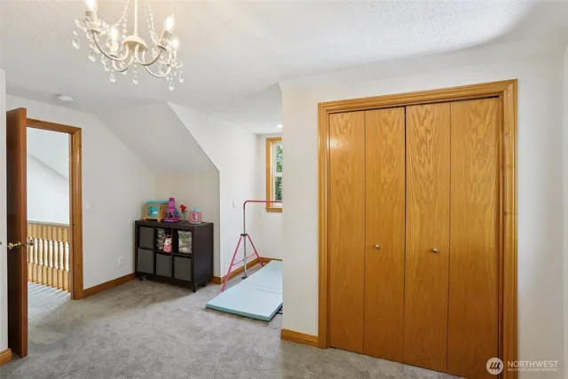 a view of a bedroom with baby toys and dresser