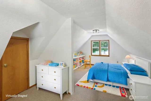 a view of a livingroom with wooden floor and a window