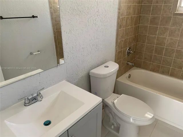 a bathroom with a sink a toilet and bathtub