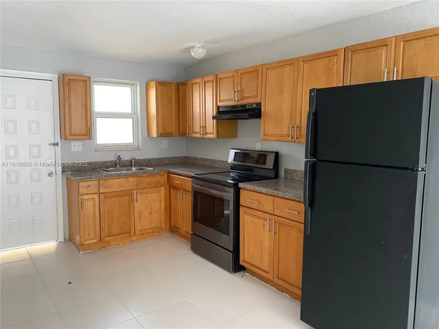 a kitchen with a refrigerator stove and microwave