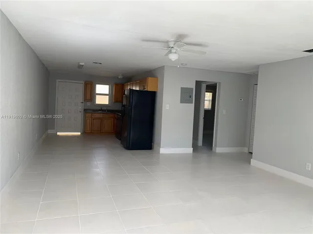 an empty room with windows and cabinet