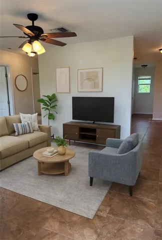 a living room with furniture and a flat screen tv
