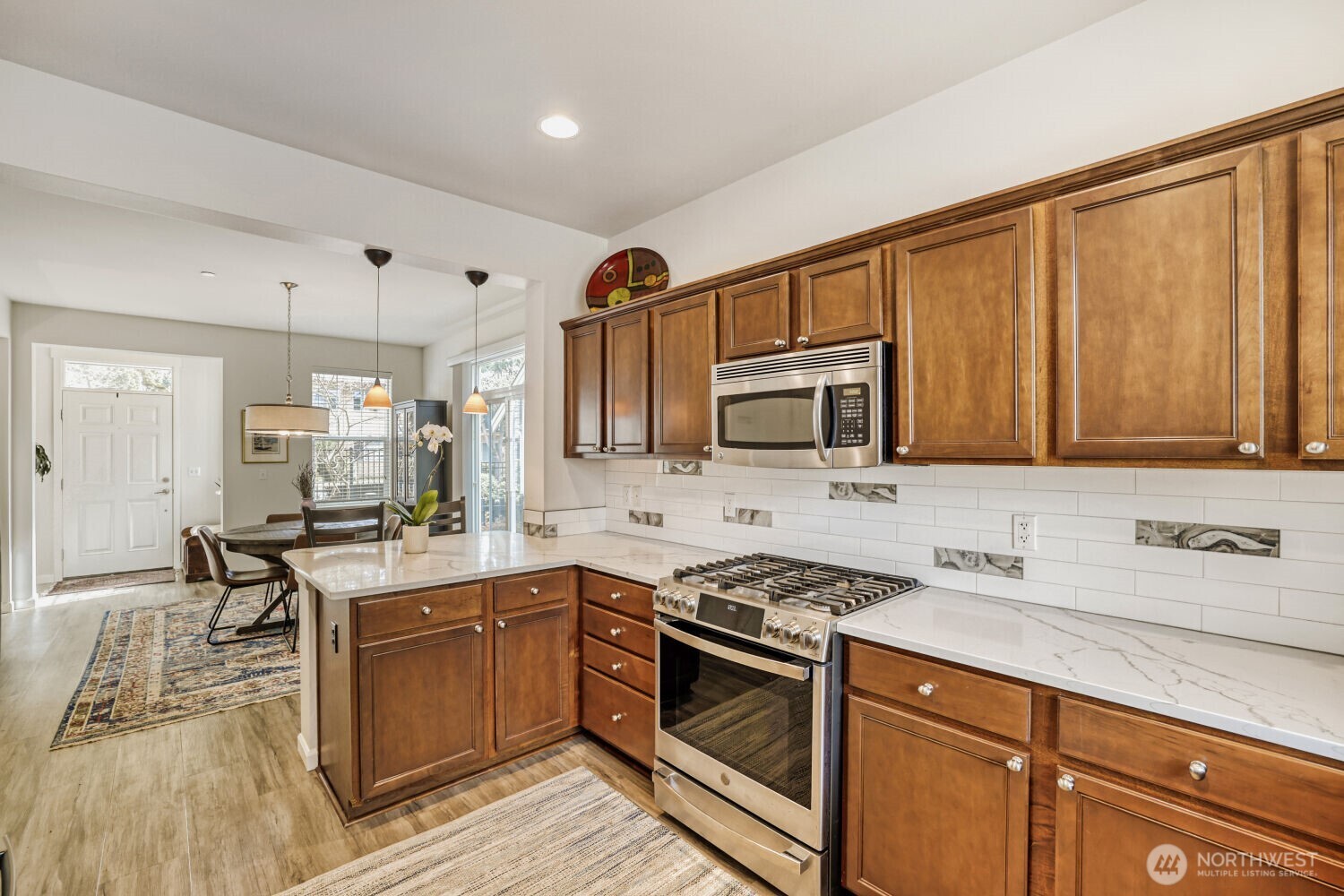 18705 101st Avenue Northeast, Unit 3 Bothell, WA 98011 - Photo 13 of 31 a kitchen with stainless steel appliances granite countertop a sink stove and cabinets