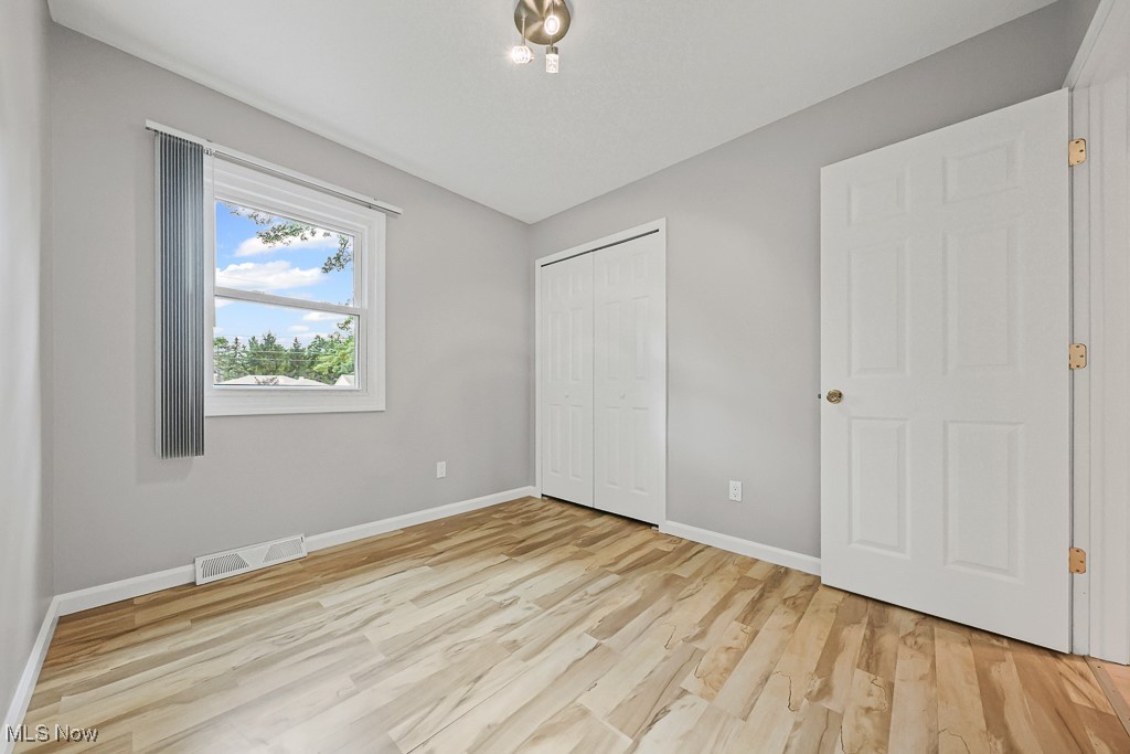 17682 Drake Road Strongsville, OH 44136 - Photo 27 of 45 Unfurnished bedroom with light wood-style flooring and a closet
