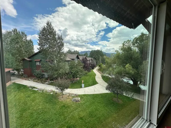 a view of a garden from a balcony