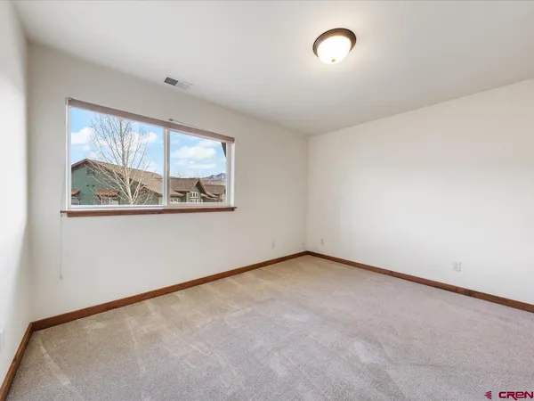 a view of a livingroom with furniture wooden floor and a window