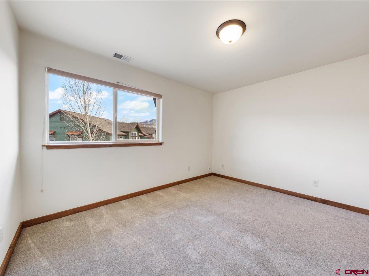 550 Redcliff Circle, Unit D202 Ridgway, CO 81432 - Photo 21 of 29 an empty room with windows