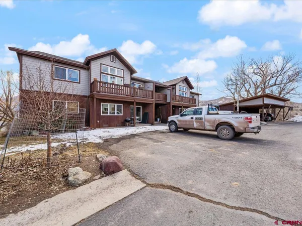 a kitchen with stainless steel appliances granite countertop a sink a refrigerator and a wooden cabinets